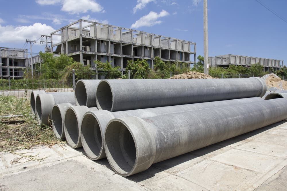 Asbestos pipes for drainage at a construction site.