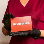 Medical consultant holding Mesothelioma Text on a sheet of paper