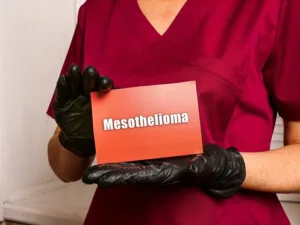 Medical consultant holding Mesothelioma Text on a sheet of paper