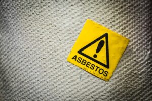 Asbestos warning sign in an old facility.