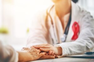 A caring doctor providing support to an elderly cancer patient