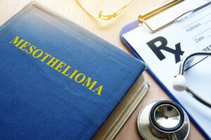 Book about Mesothelioma and stethoscope on a table.